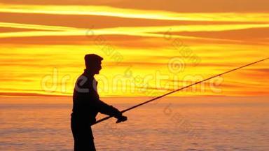 渔人剪影：海上日落时的钓鱼竿